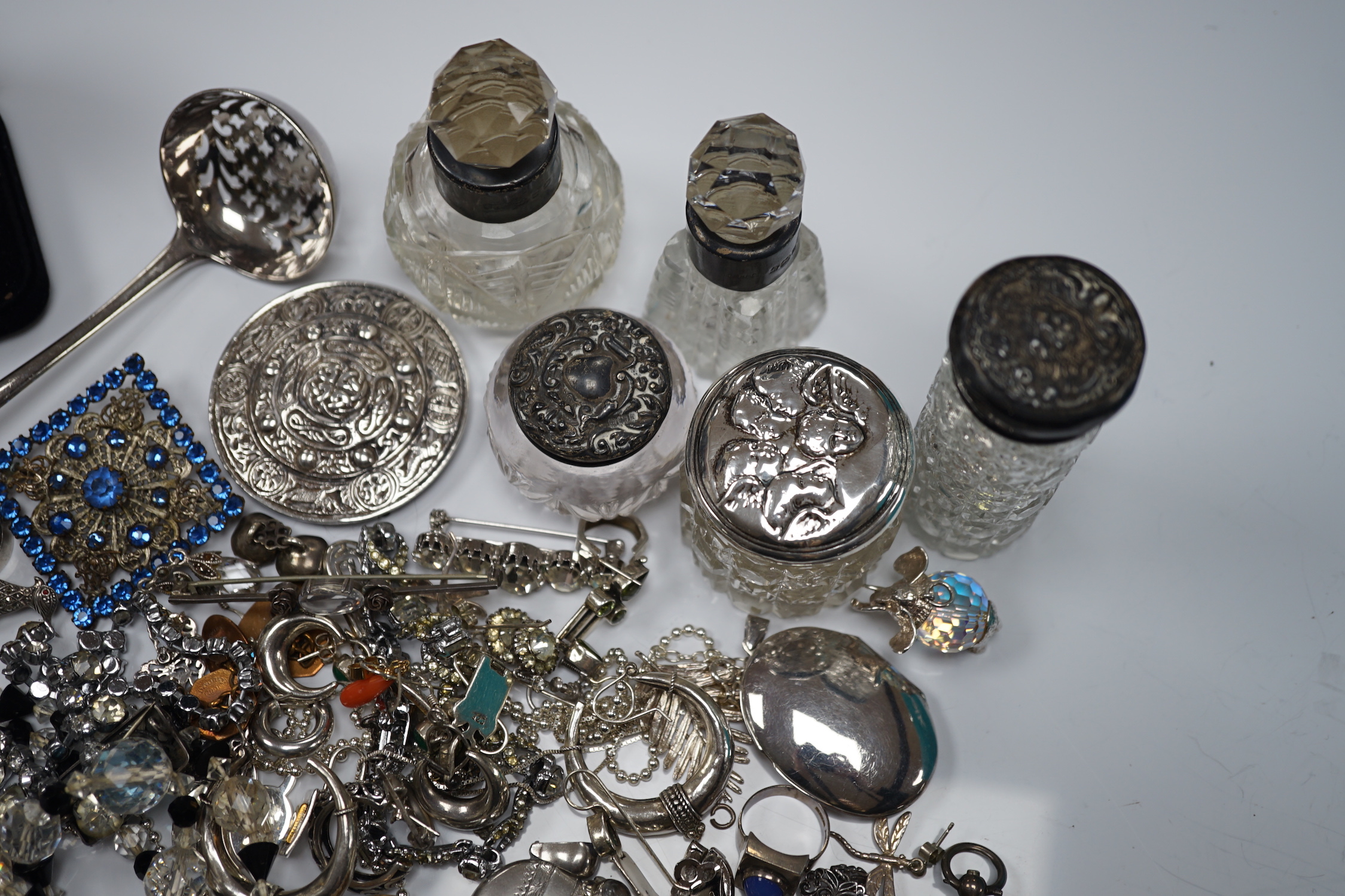 Sundry small silver including mounted glass toilet jars and a Georgian sifter spoon, together with assorted silver and other jewellery including earrings, pendants, brooches etc.